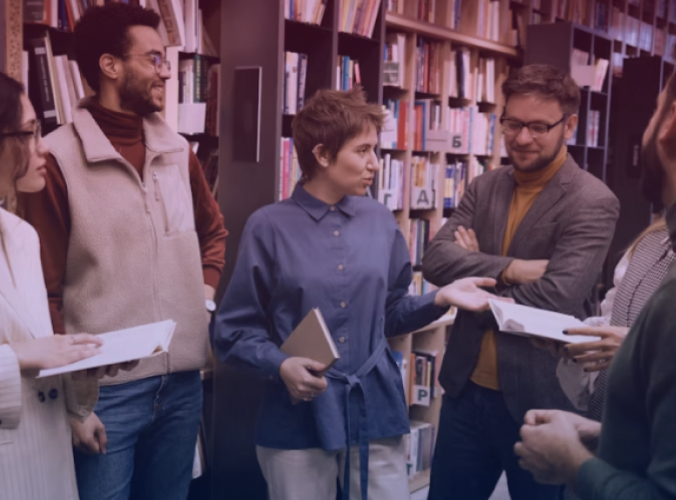 A guide leads a study group in a library.