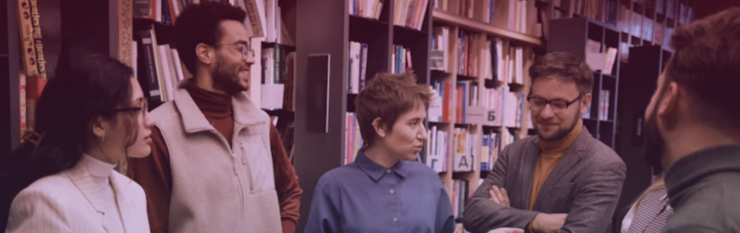A guide leads a study group in a library.