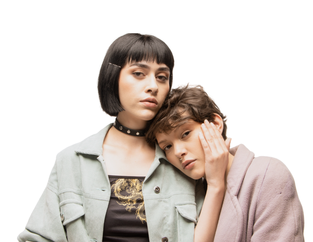 Two individuals posing; one with their head on the other's shoulder