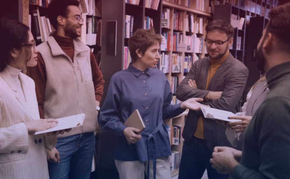 A guide leads a study group in a library.