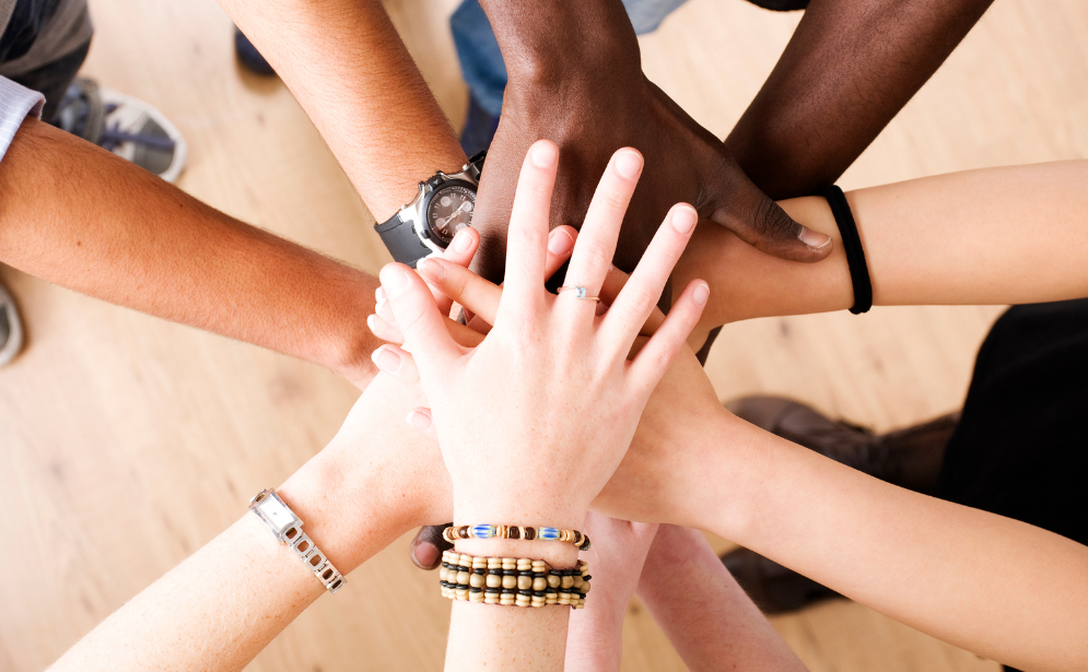 A unity of lgbtq individuals building bonds through interconnected hands